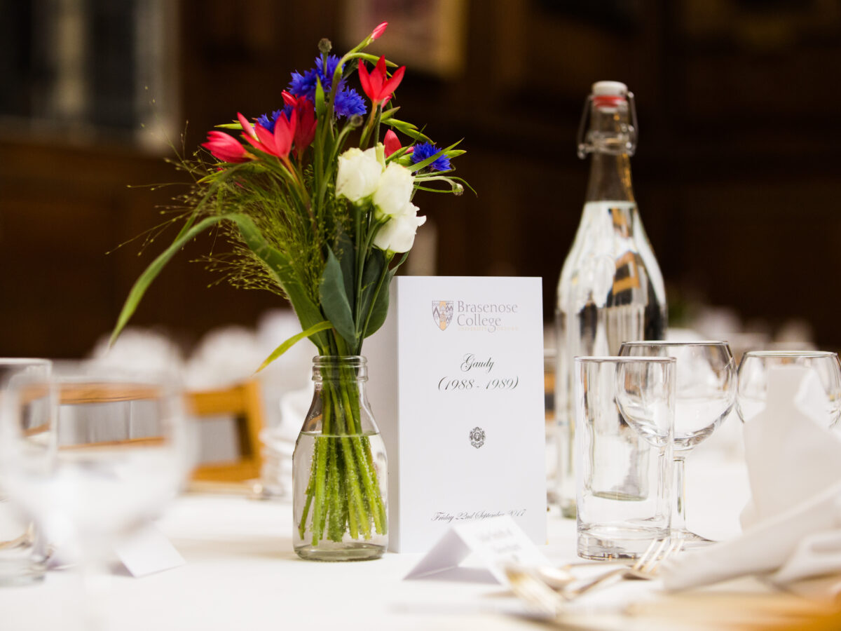 Floral arrangement and place setting on a dining table for the Gaudy 1988 and 1989