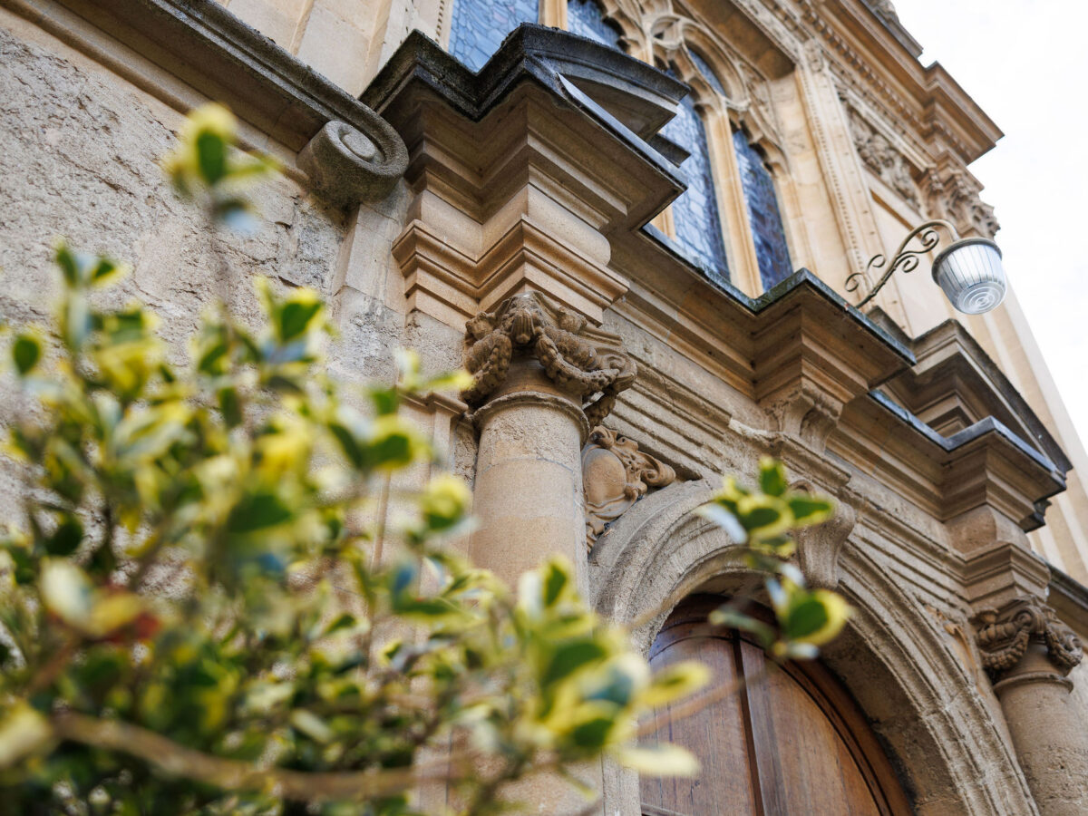 Close-up of carved stone architectural detail on a college building