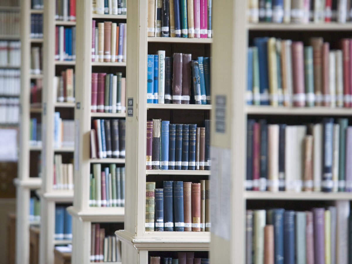 Tall bookshelves filled with books in a college library