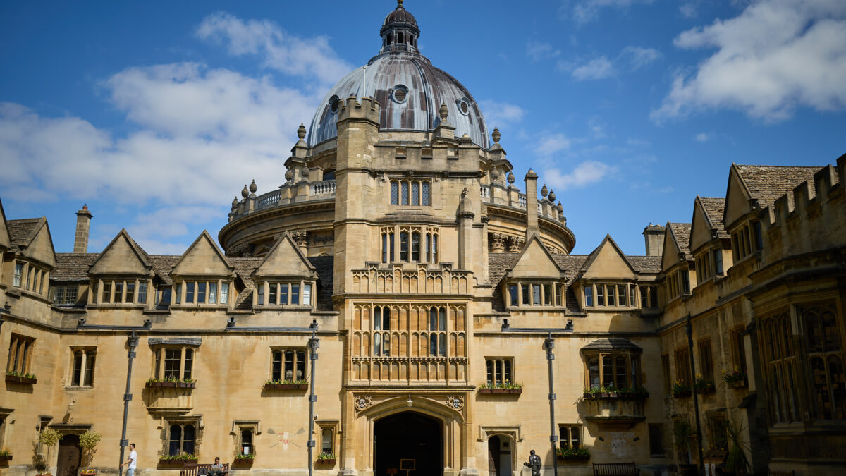 Brasenose College Old Quad in the sunshine against a blue sky with the Radcliffe Camera in the background