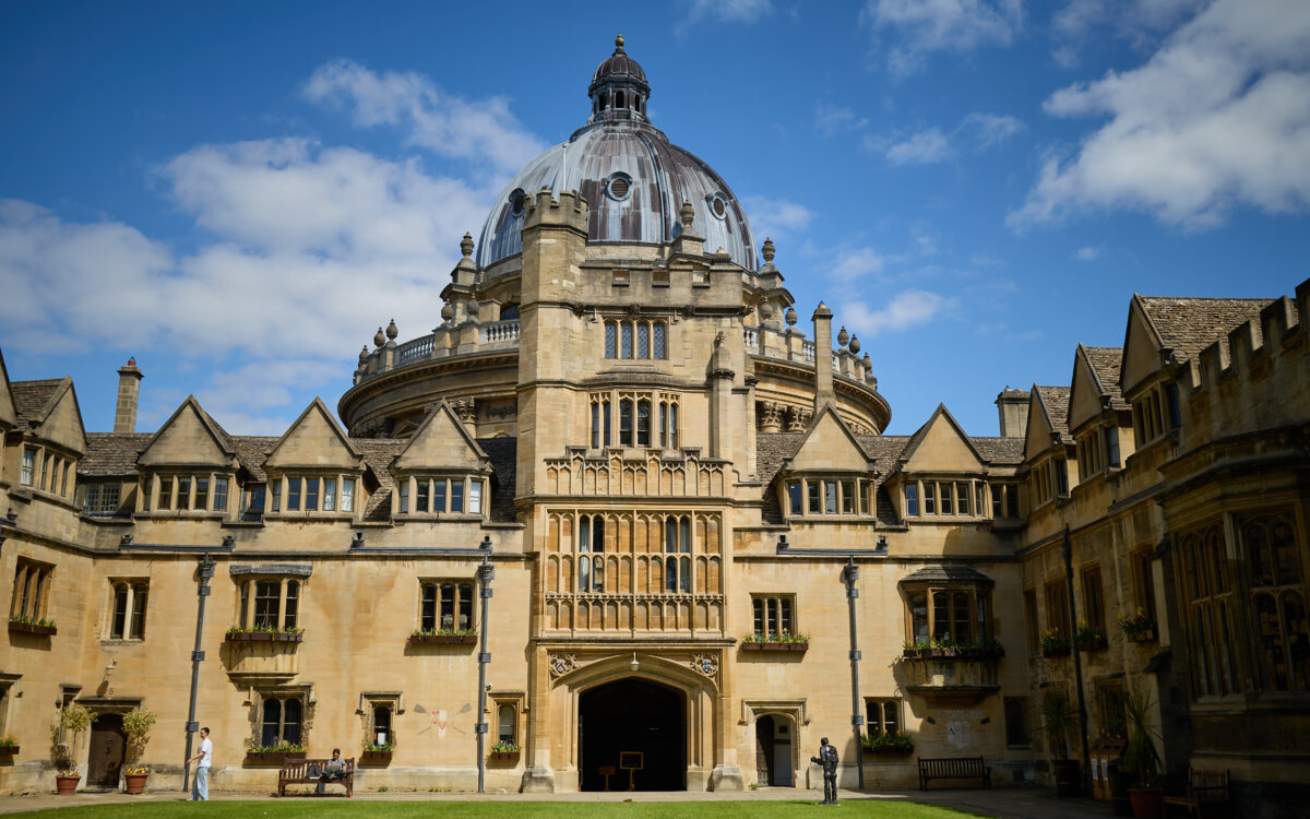 Brasenose College Old Quad in the sunshine against a blue sky with the Radcliffe Camera in the background