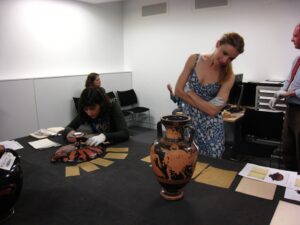 Image of Sophie Bocksberger examining a pot as part of her research.