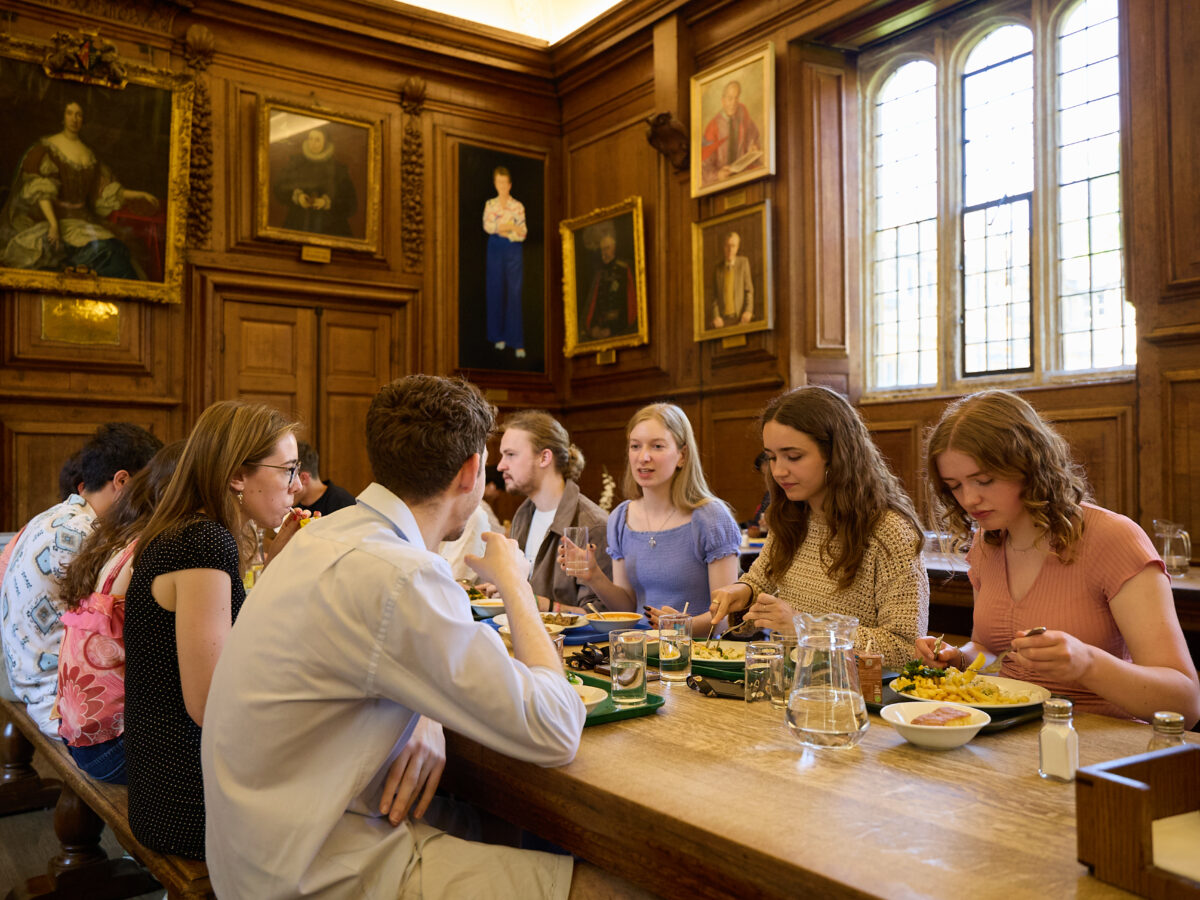 A group of students eating a meal together in Hall.