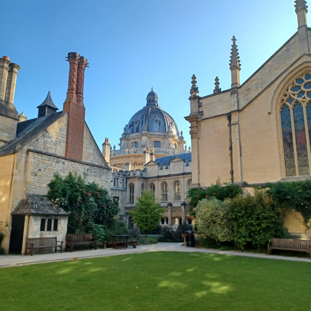 College lawn with historic buildings in the background