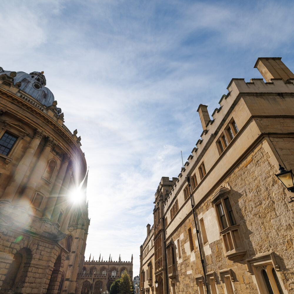 View of historic college buildings. The Radcliffe Camera on the left and Brasenose College to the right