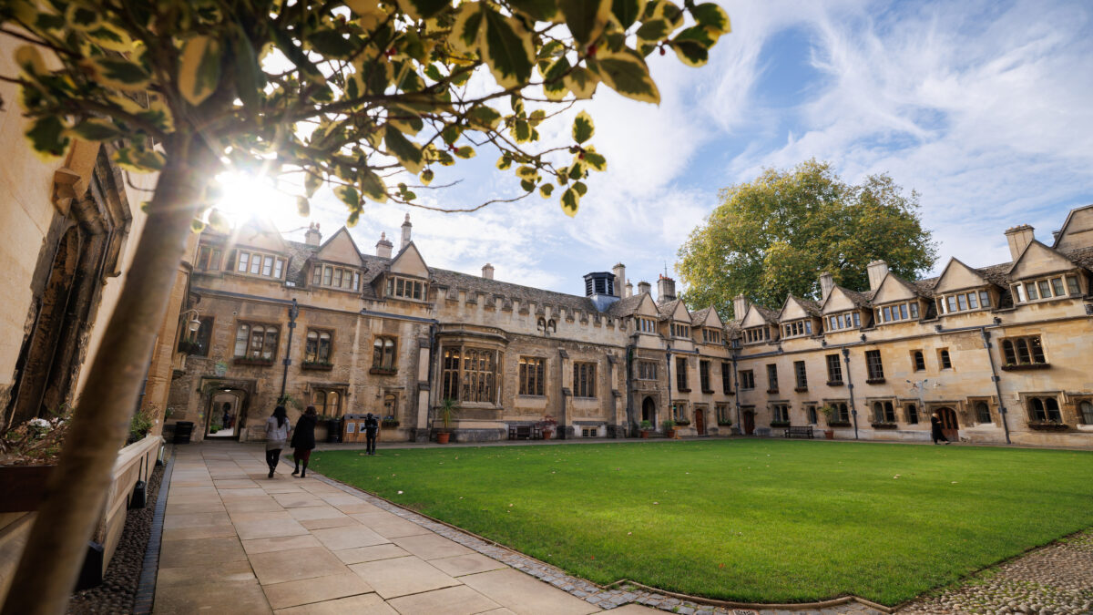 Wide view of the college quad with buildings and lawn