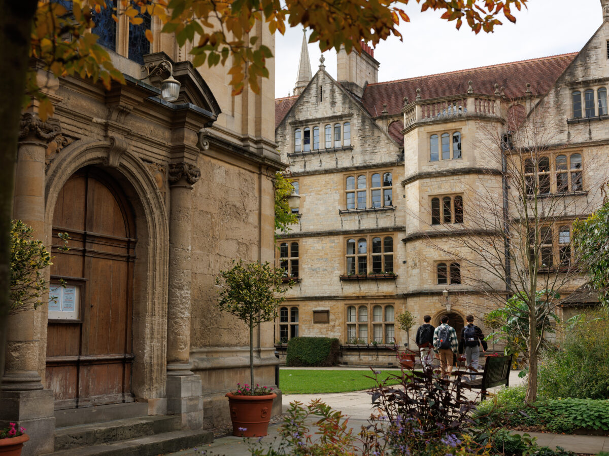 Three students walking across the quad at Brasenose College