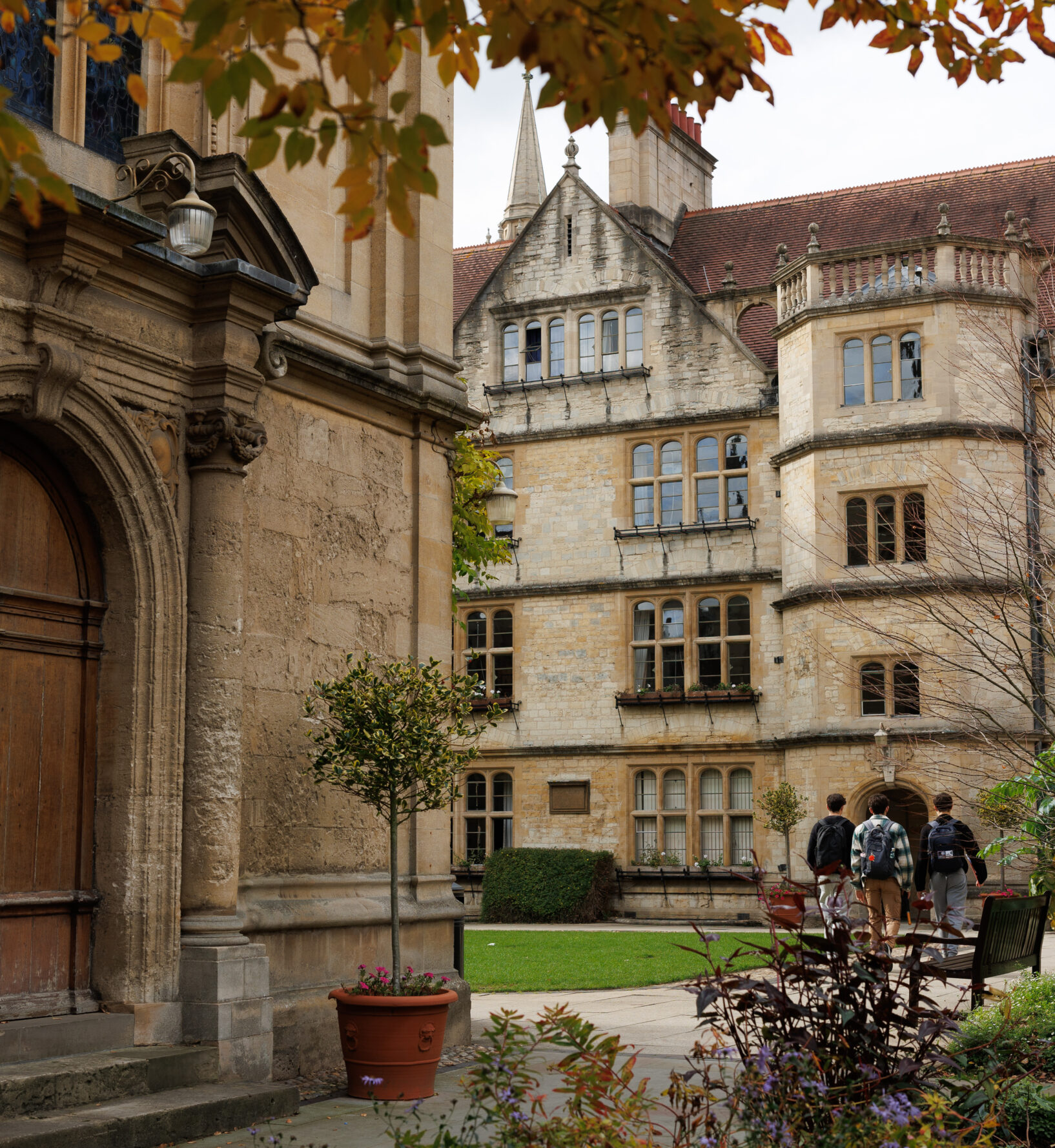 Three students walking across the quad at Brasenose College