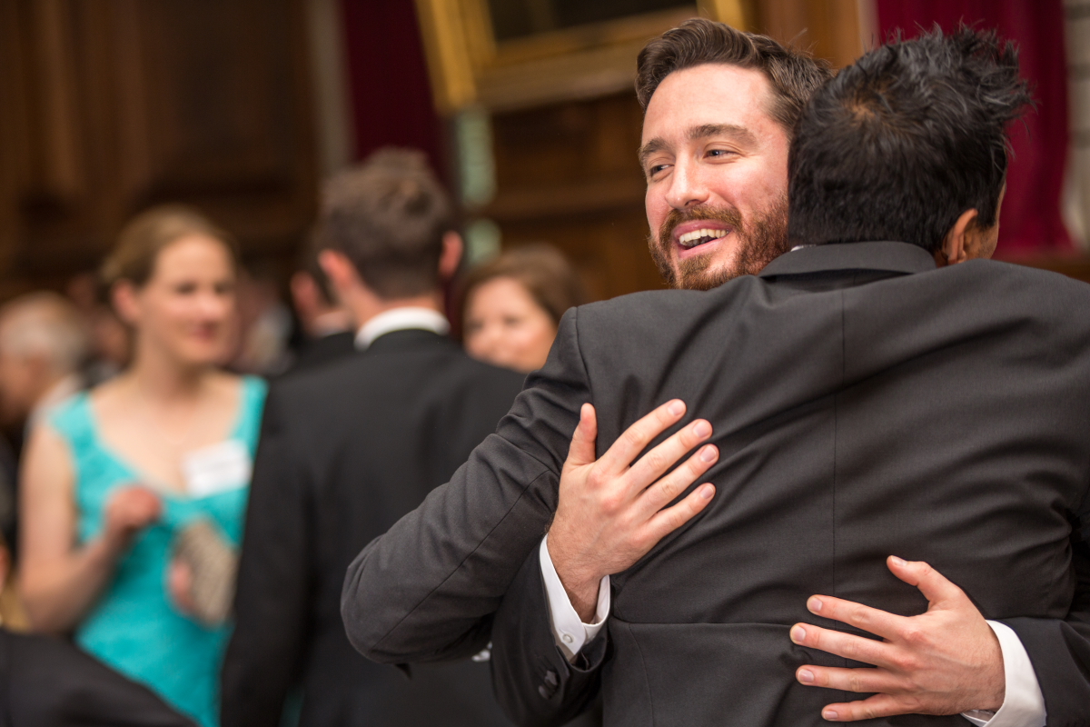 Two people embracing indoors at the Gaudy 2001 and 2002 event in 2016