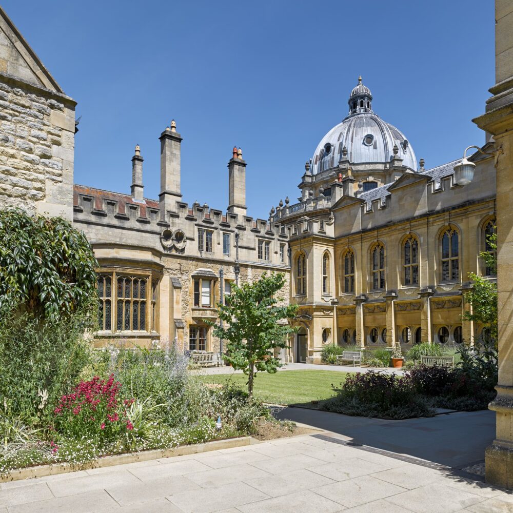Exterior view across Deer Park towards the library on a sunny day with a blue sky