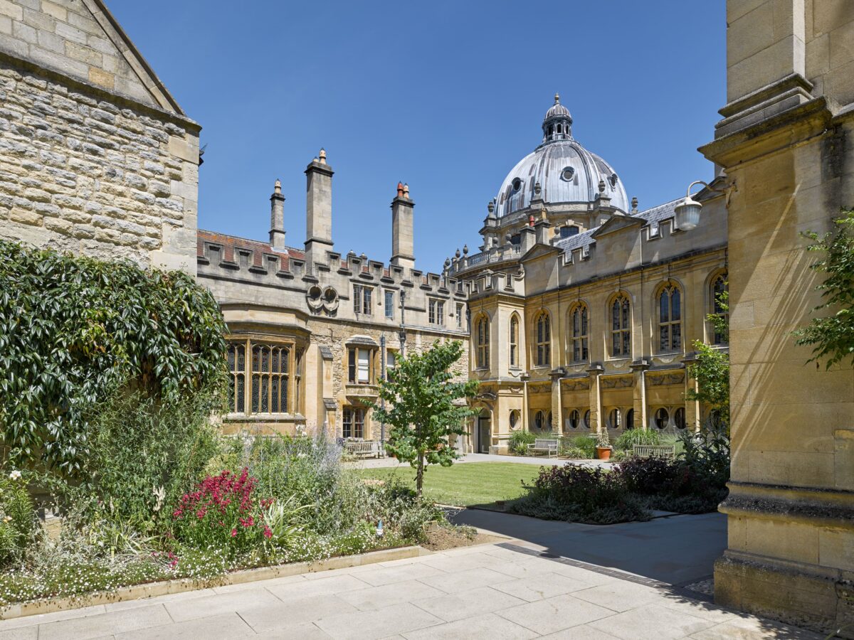 Exterior view across Deer Park towards the library on a sunny day with a blue sky