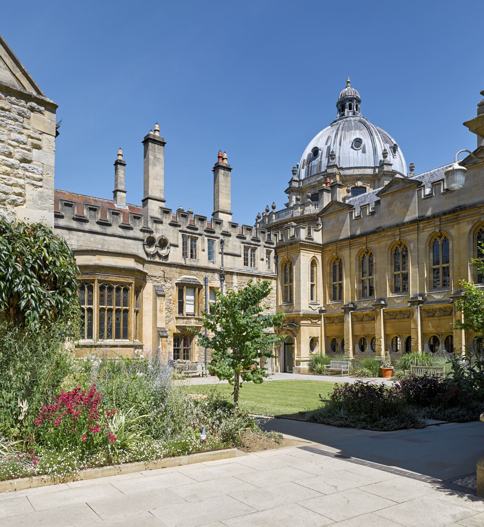 Exterior view across Deer Park towards the library on a sunny day with a blue sky
