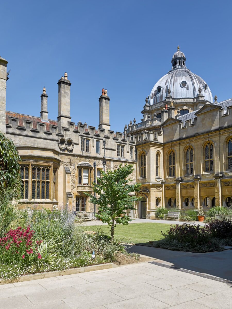 Exterior view across Deer Park towards the library on a sunny day with a blue sky