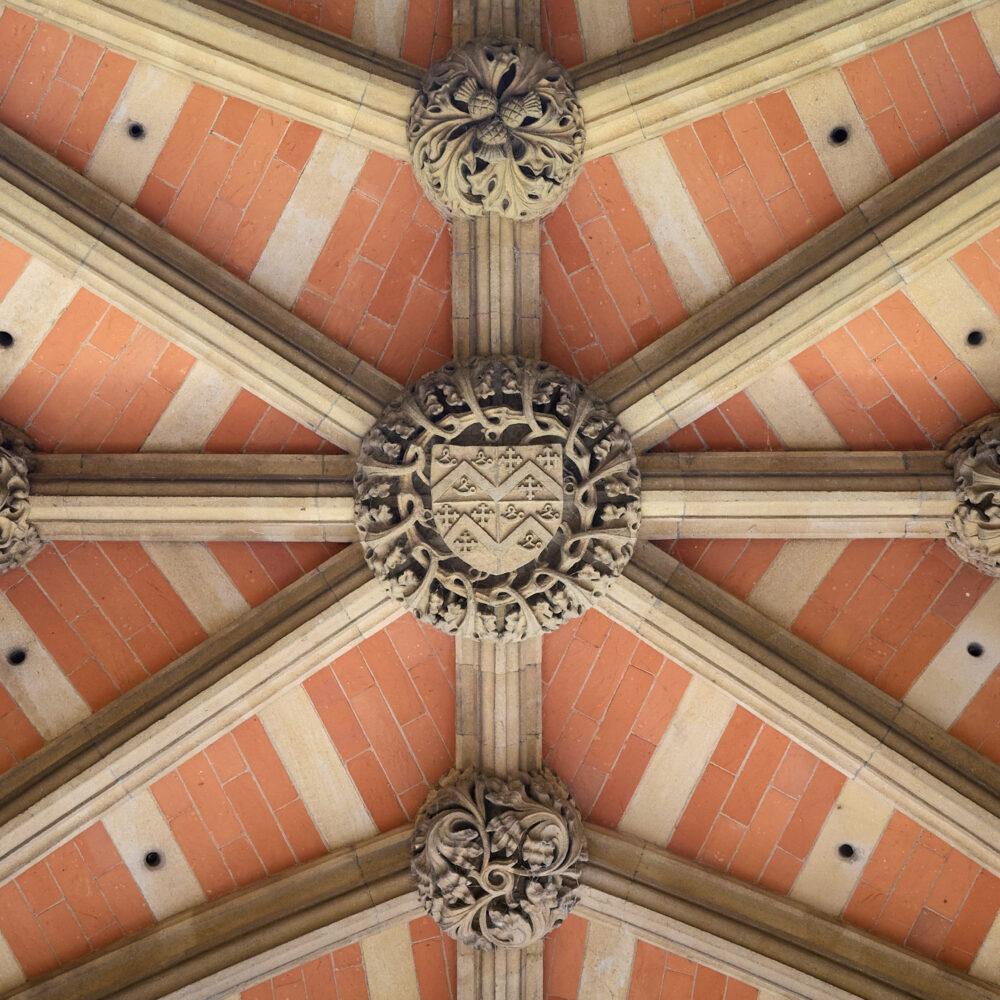 Ornate painted ceiling viewed from directly below inside a historic building