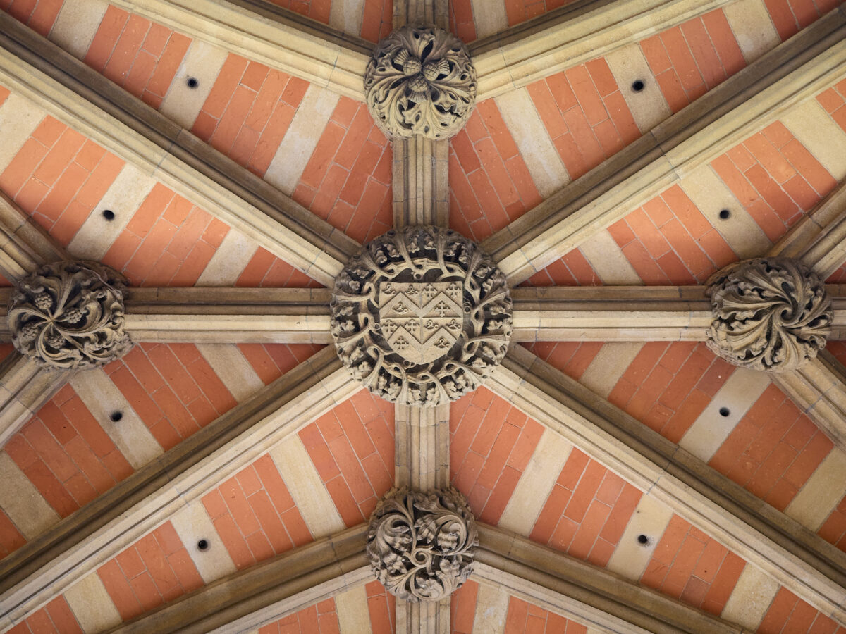 Ornate painted ceiling viewed from directly below inside a historic building