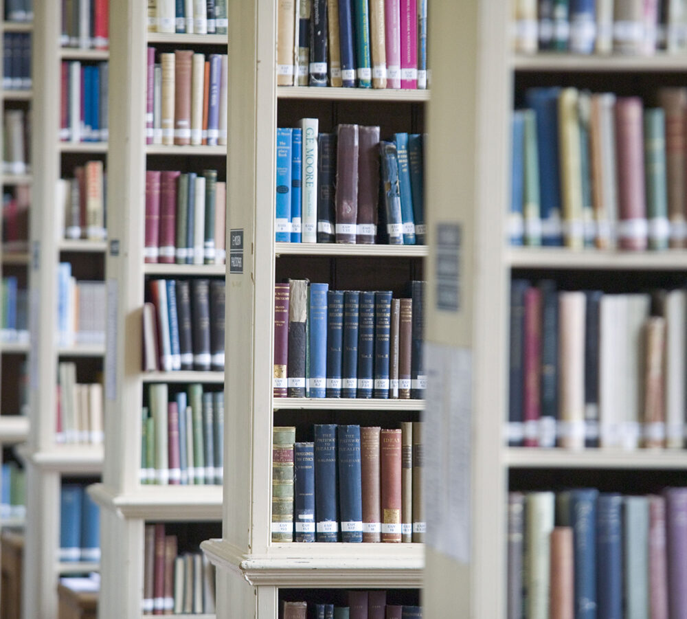 Tall bookshelves filled with books in the Greenland Library