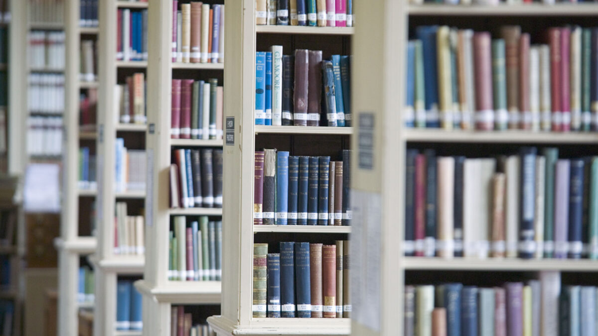 Tall bookshelves filled with books in the Greenland Library