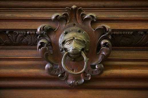 Brazen nose knocker above High Table