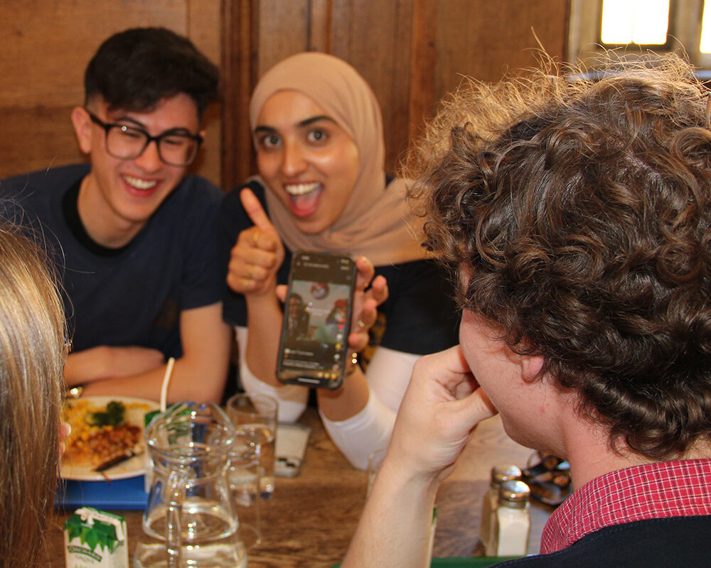 Students sitting together eating and chatting