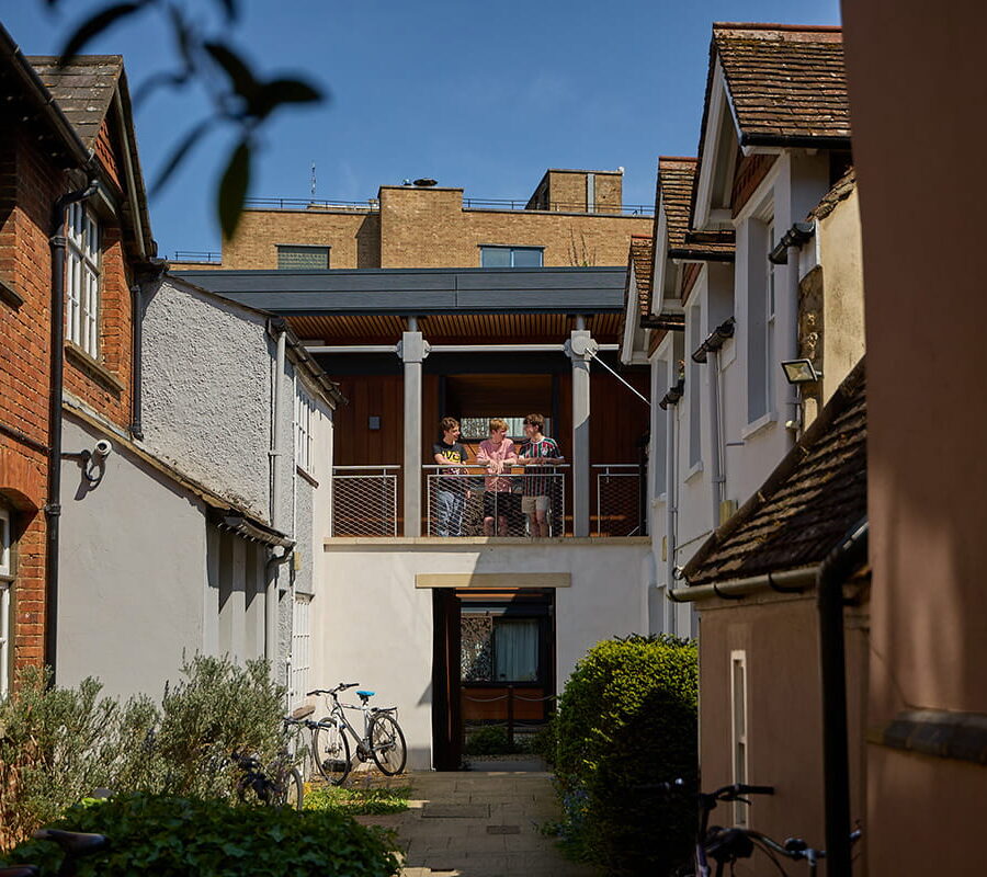 Students standing on a balcony overlooking a Brasenose College accommodation courtyard