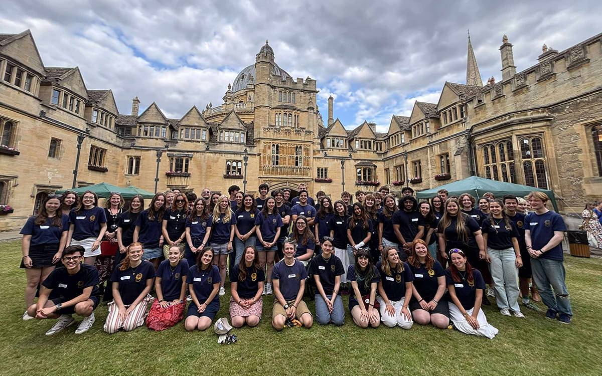 Group photo of students gathered together on the college quadrangle.