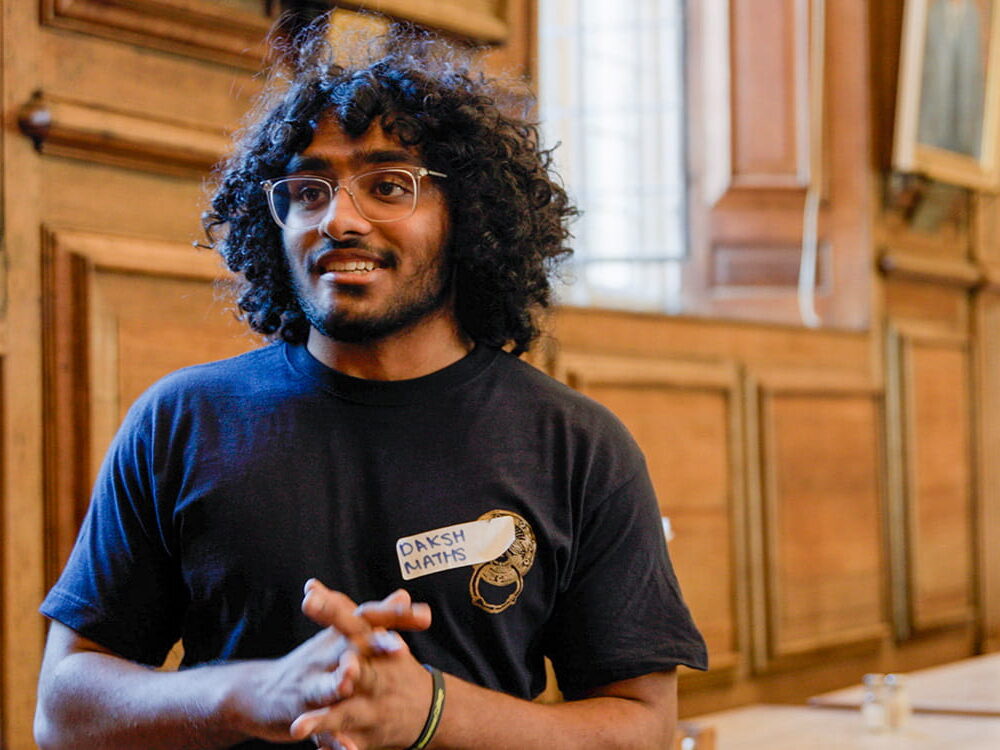Student volunteer addressing a group in a college room
