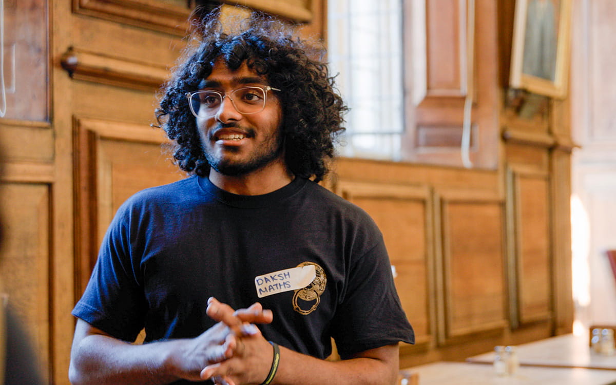 Student volunteer addressing a group in a college room