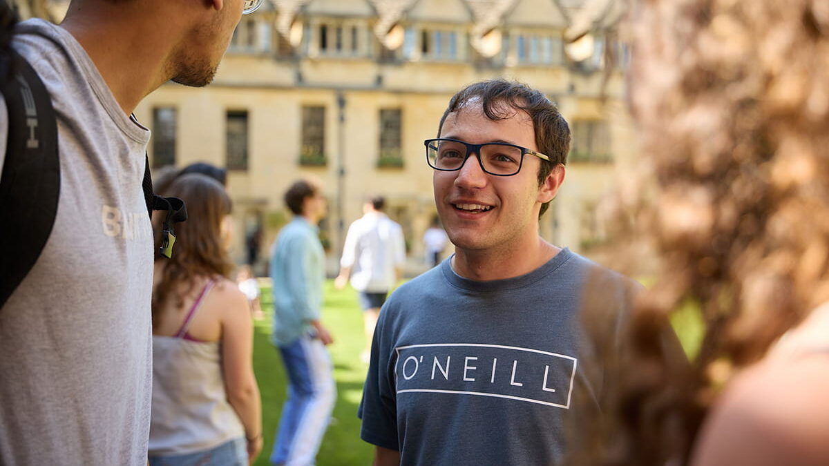 Postgraduate students chatting together in the quad