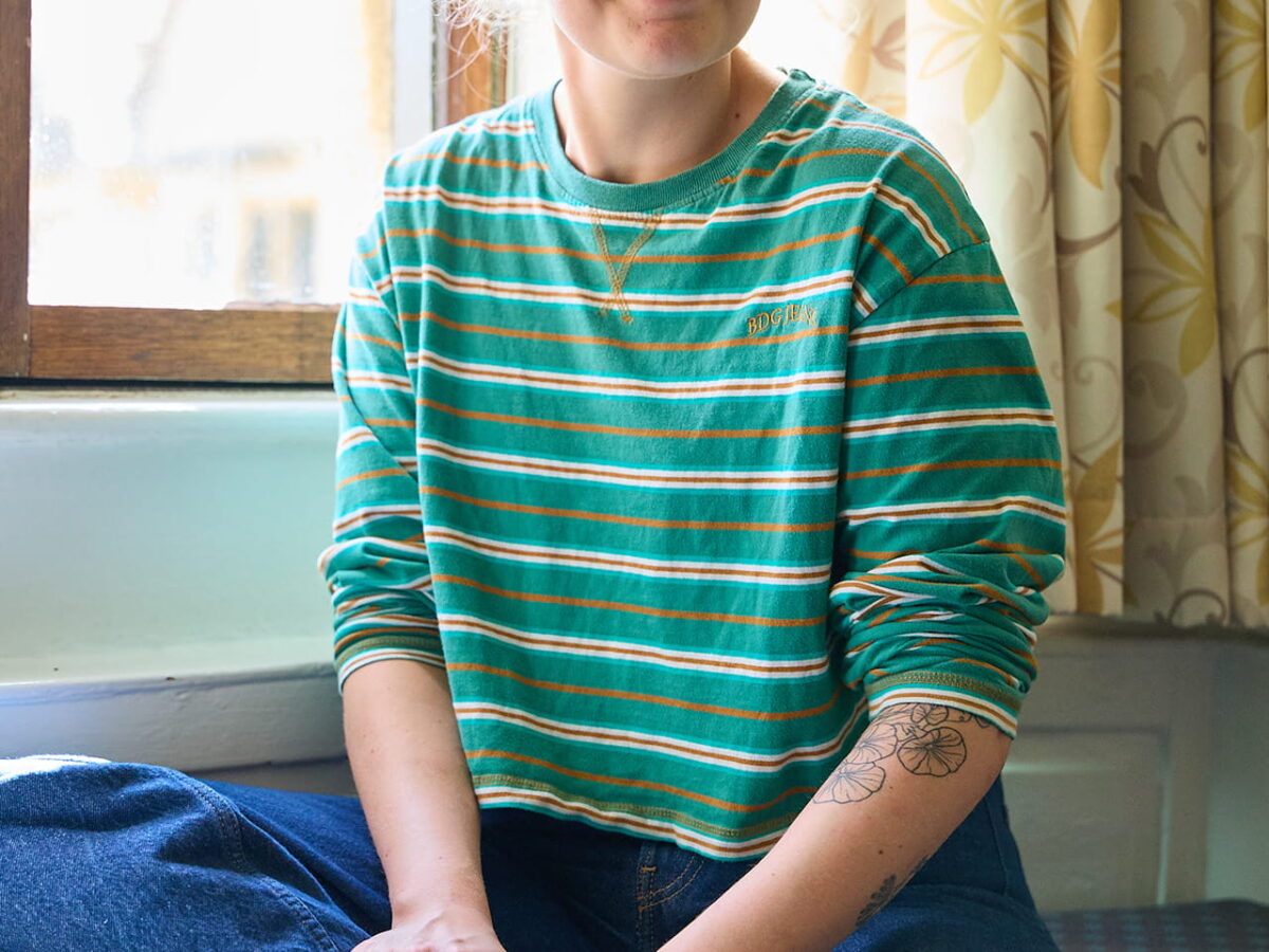 Student sitting by a window in a college room
