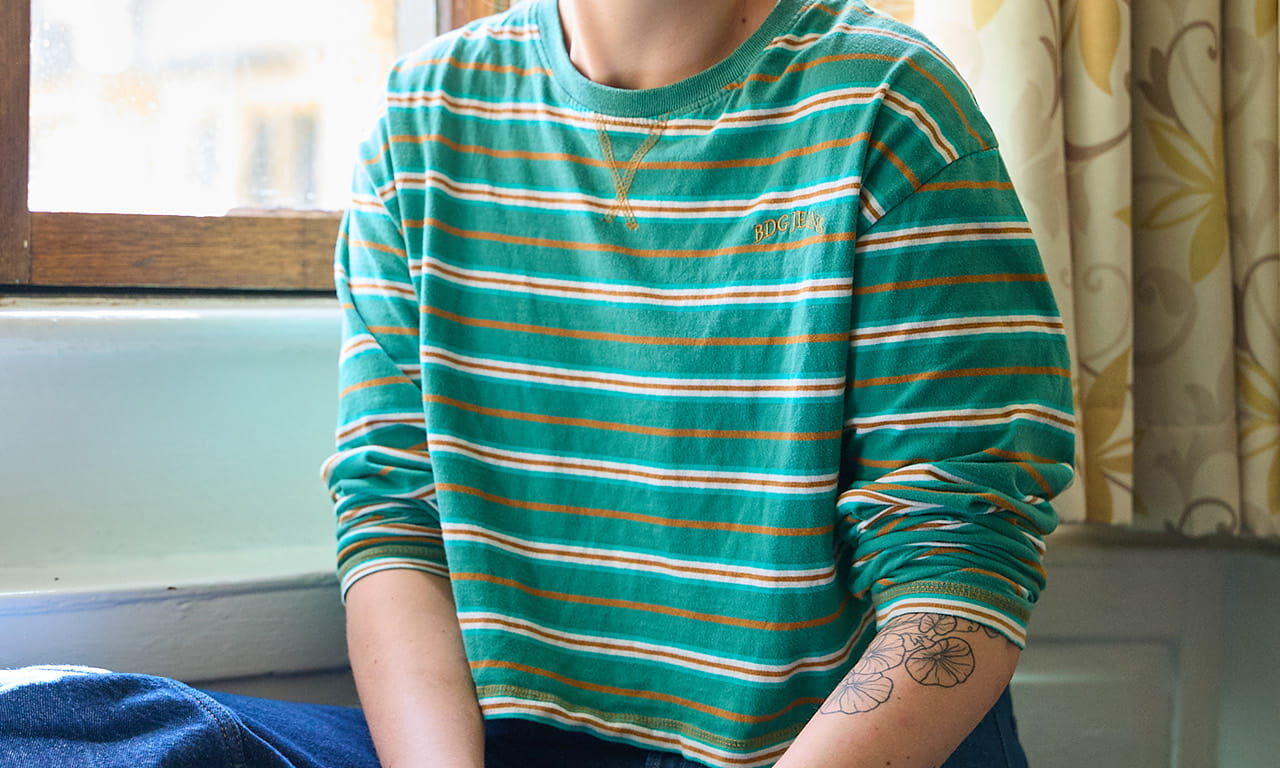 Student sitting by a window in a college room