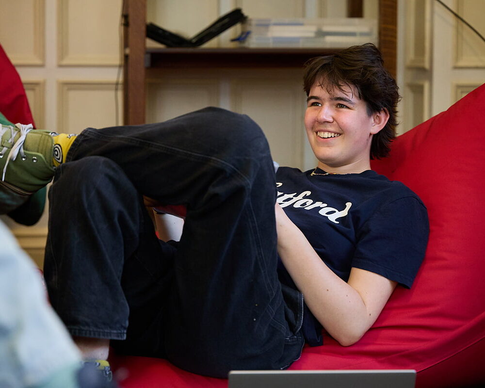 Student relaxing on a beanbag in the common room