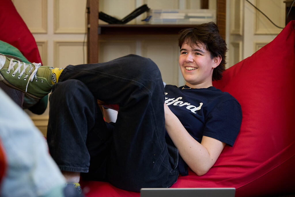 Student relaxing on a beanbag in the common room