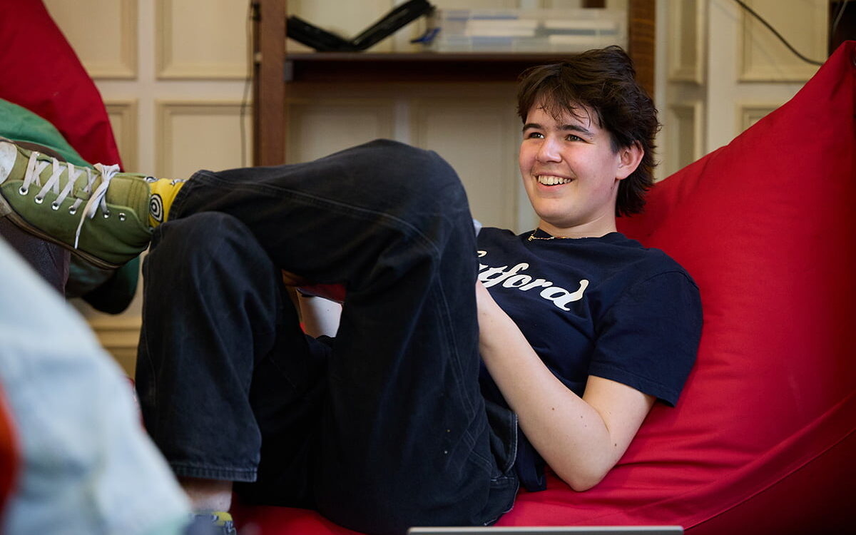 Student relaxing on a beanbag in the common room