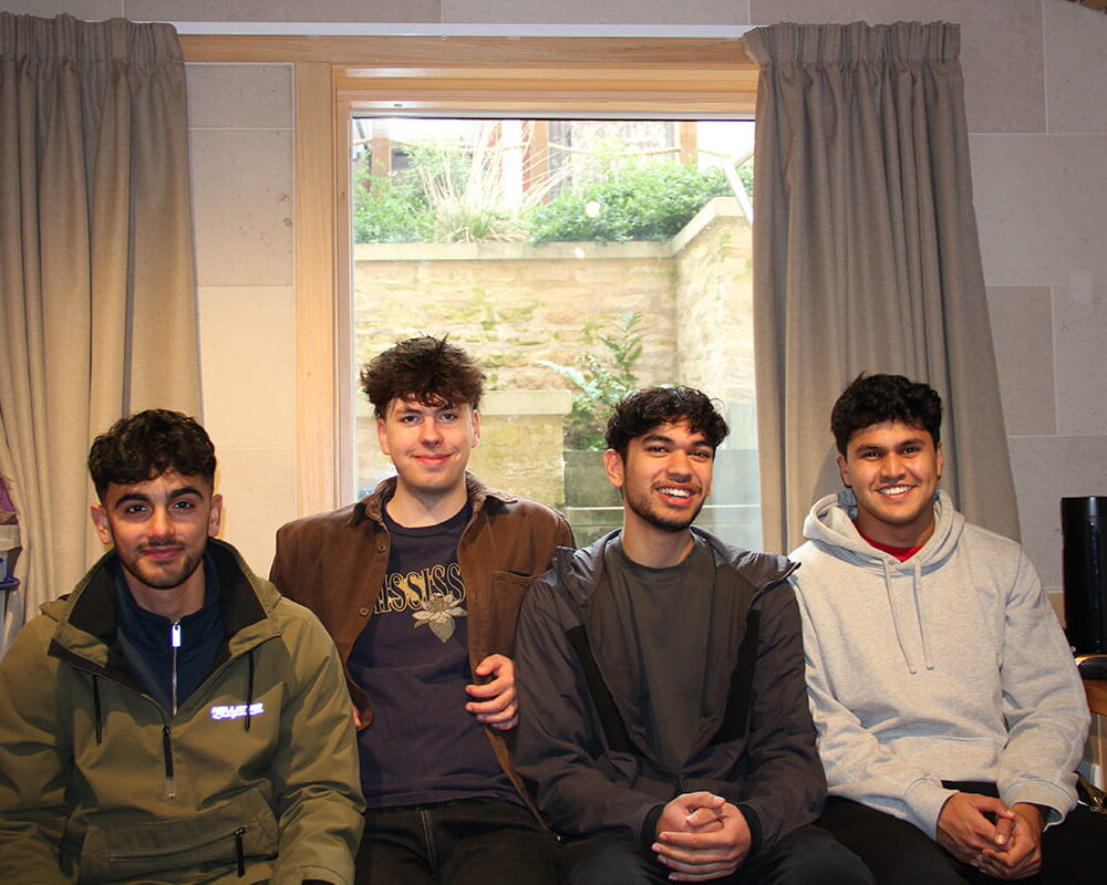 Four students sitting together in accommodation