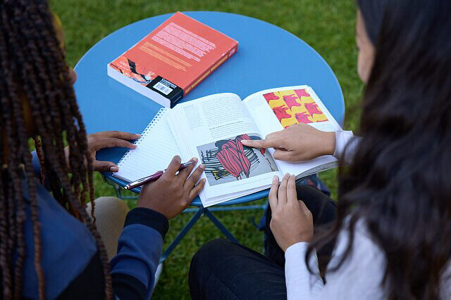 People pointing at a page