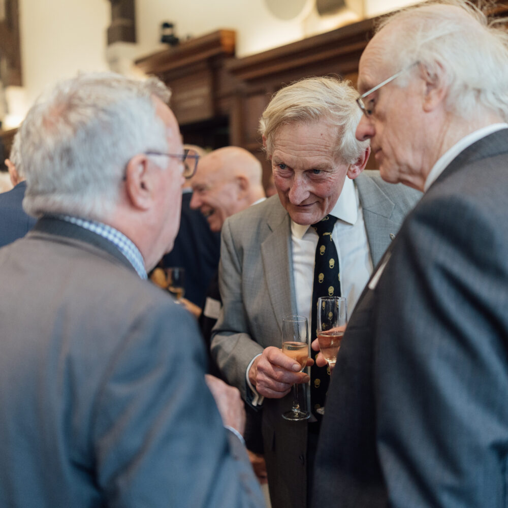 Group of three alumni laughing whilst attending the Diamond Jubilee