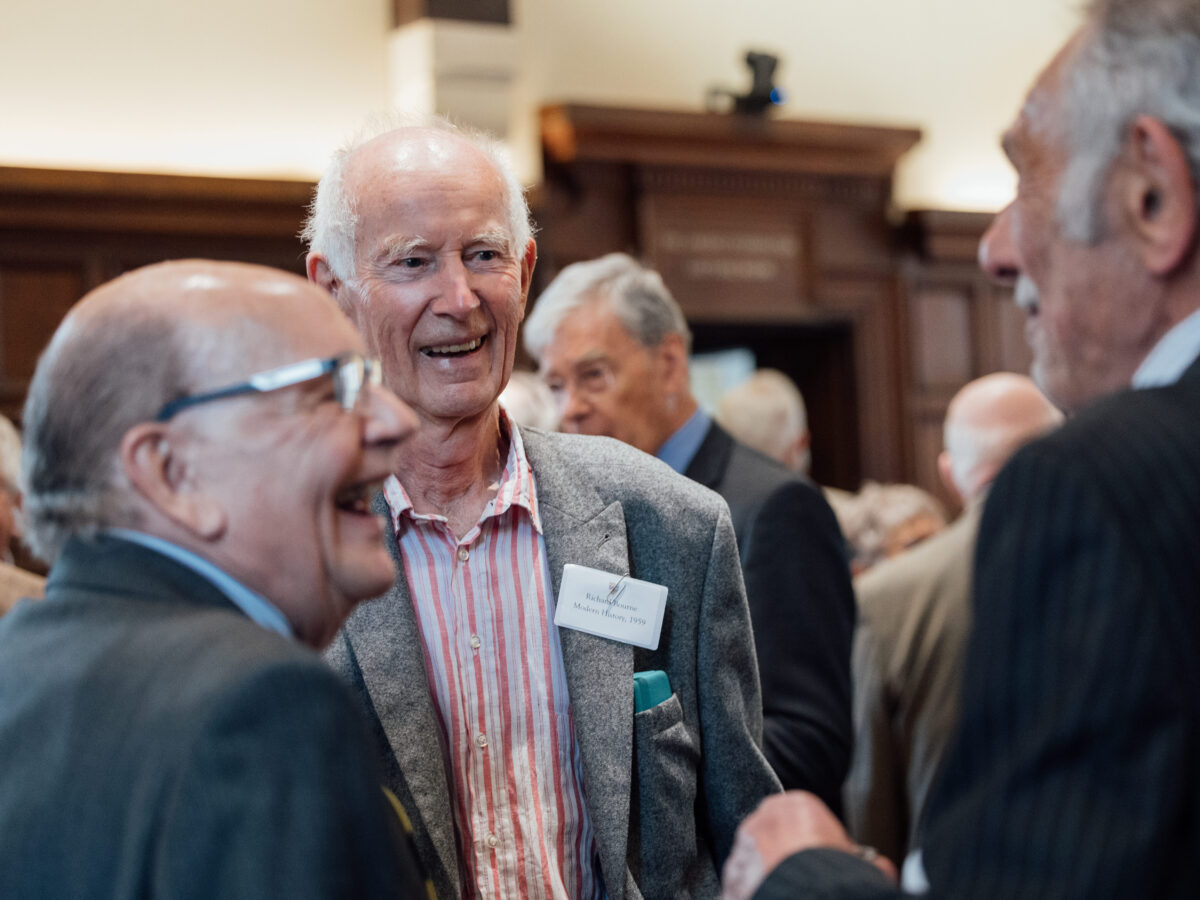 Group of three alumni laughing whilst attending the Diamond Jubilee