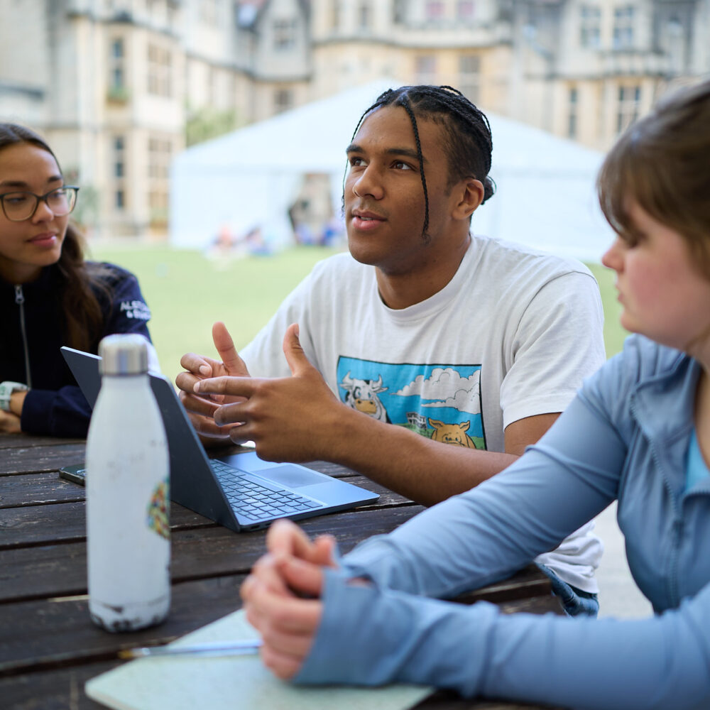 Three students sat in New Quad studying together