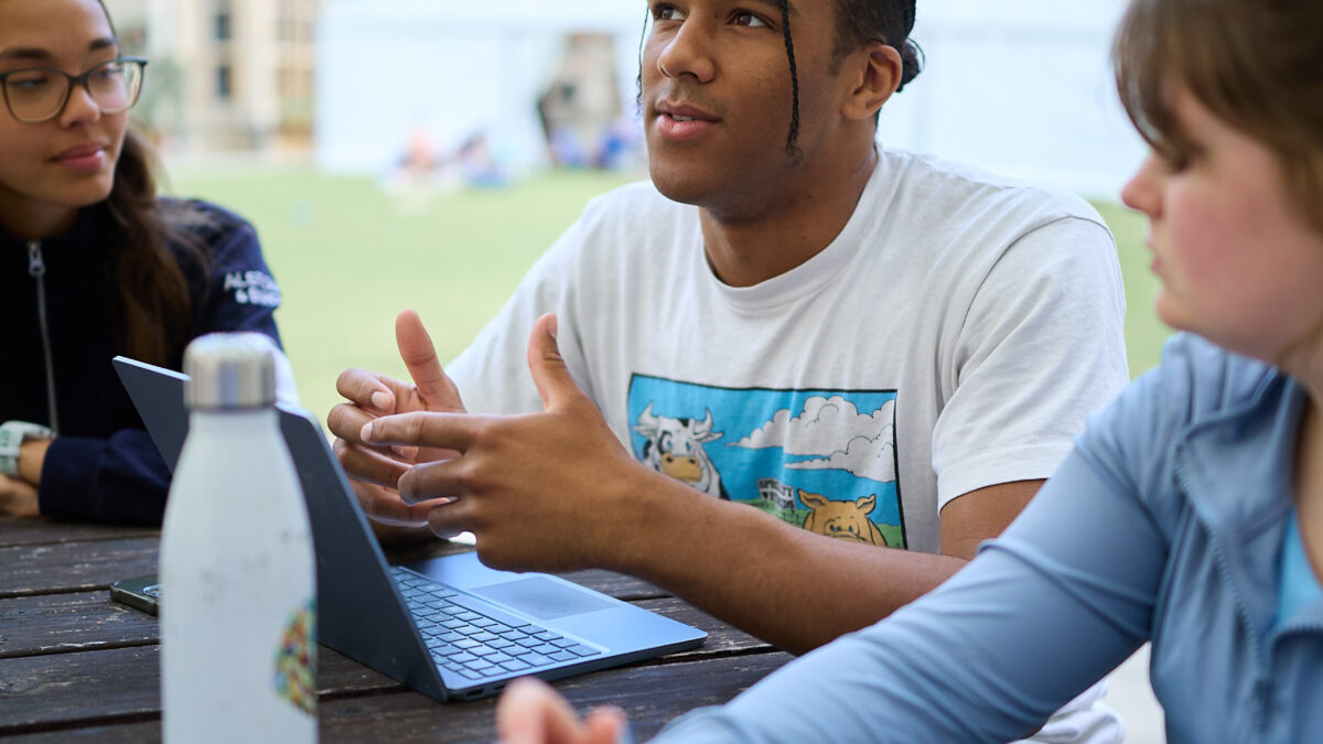 Three students sat in New Quad studying together