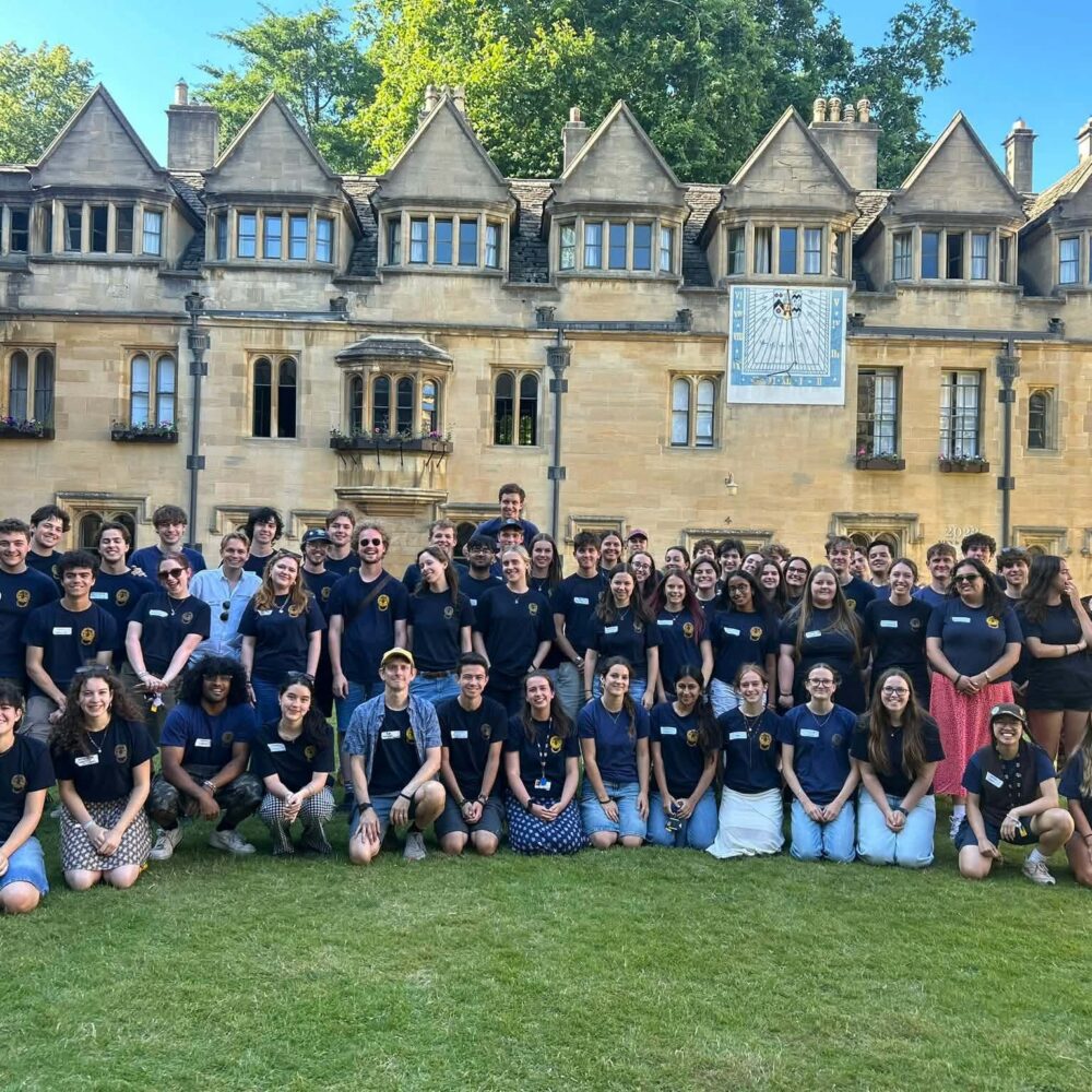 Team of Student helpers all wearing dark blue shirts posing in Old Quad