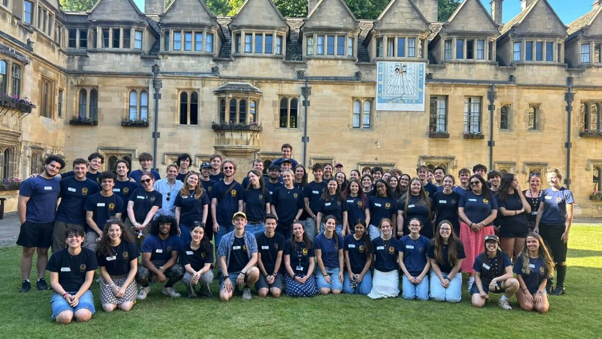 Team of Student helpers all wearing dark blue shirts posing in Old Quad