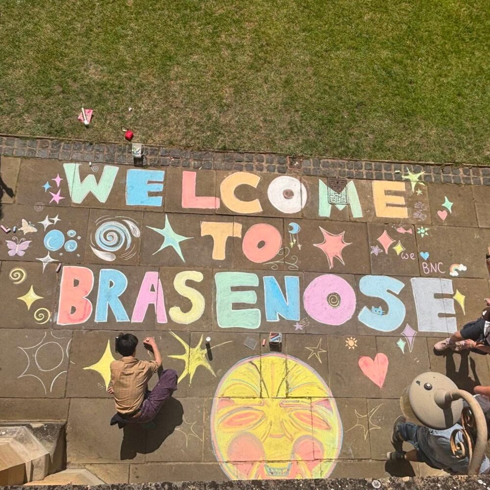 Welcome to Brasenose chalked on to flagstones in bright colours
