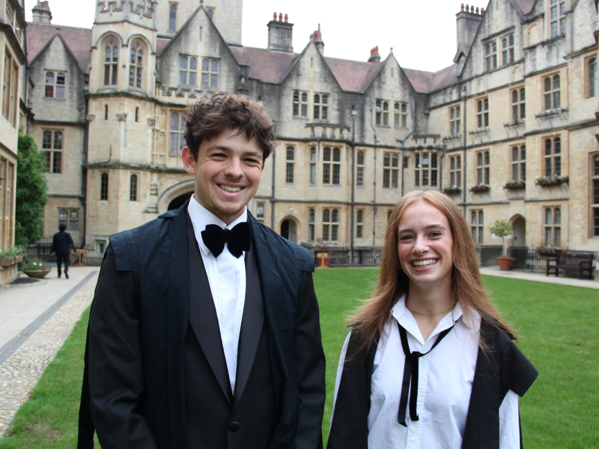 Two students wearing sub fusc, Oxford's academic dress, in New Quad
