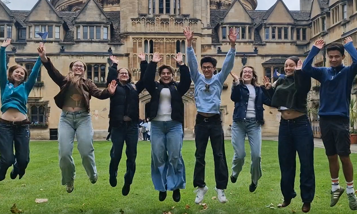 Students jumping in celebration in the Old Quad